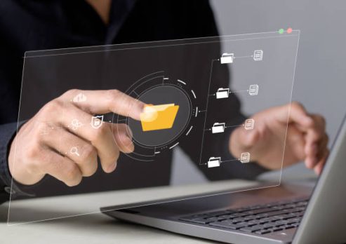 businessman typing on virtual screen, document management system online documentation database and process automation to efficiently manage files, knowledge and documentation in enterprise.